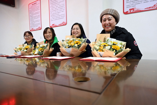 退休干部手捧鲜花，满怀喜悦踏上新征程。1.jpg