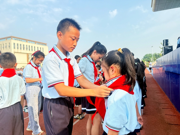 老队员为新队员佩戴红领巾.JPG